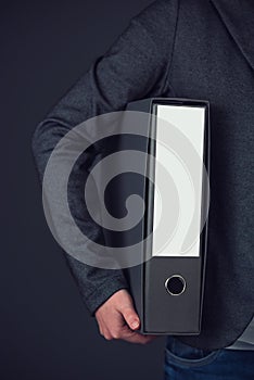 Businesswoman holding document ring binder with blank label as c