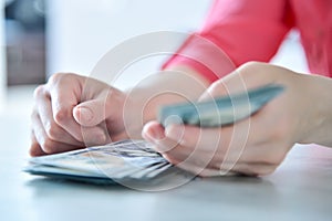 Businesswoman holding dollars banknote in hand