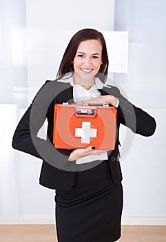 Businesswoman Holding First Aid Box