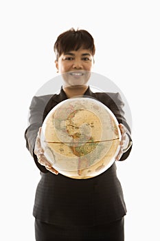 Businesswoman holding globe.