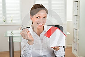 Businesswoman Holding Key And House Model