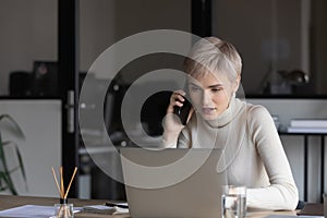 Businesswoman holding mobile phone talking consulting to client