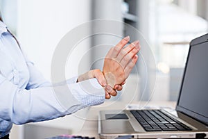 Businesswoman Holding Painful Wrist At Office