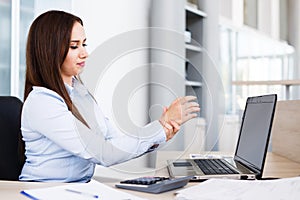 Businesswoman Holding Painful Wrist At Office