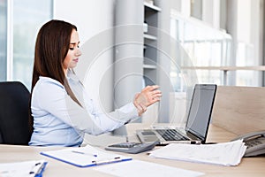 Businesswoman Holding Painful Wrist At Office