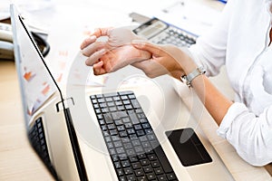 Businesswoman Holding Painful Wrist At Office