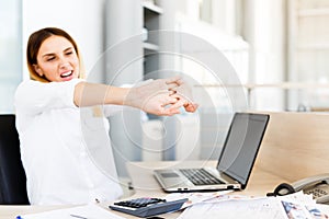 Businesswoman Holding Painful Wrist At Office