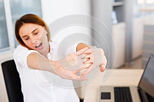 Businesswoman Holding Painful Wrist At Office