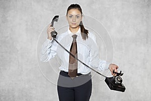 Businesswoman is holding the phone away from her ear