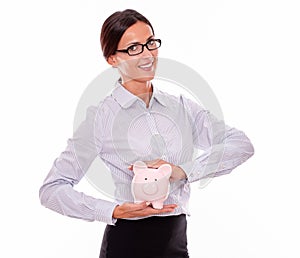 Businesswoman holding pink porcelain piggy bank