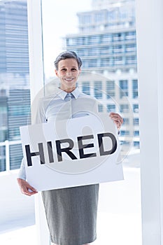 Businesswoman holding a signboard hired