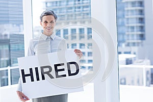 Businesswoman holding a signboard hired