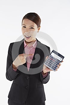 Businesswoman holding up a calculator