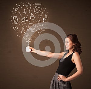 Businesswoman holding a white cup with social media icons