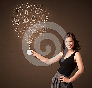 Businesswoman holding a white cup with social media icons