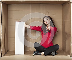 Businesswoman holds a copy space and pointing at you