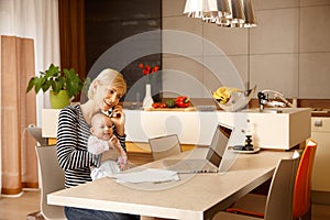 Businesswoman at home with baby