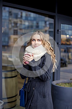 Businesswoman in a hurry to work with a cup of coffee. outdoor shot