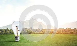 Businesswoman inside light bulb