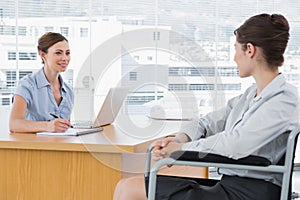 Businesswoman interviewing disabled candidate