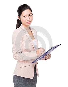 Businesswoman jot note on clipboard