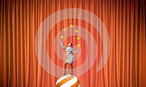 Businesswoman juggling with balls