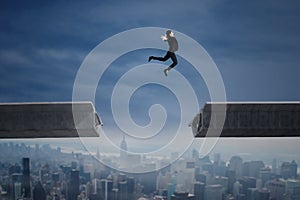 Businesswoman jumping over a gap in the bridge