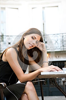 Businesswoman with laptop in cafe.