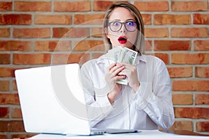 businesswoman with laptop computer and money