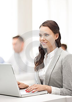 Businesswoman with laptop computer at work