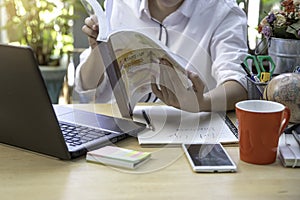 A businesswoman with laptop and mobilephone on workspace in modern office