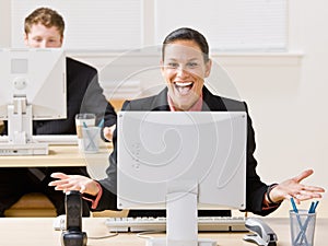 Businesswoman laughing at monitor