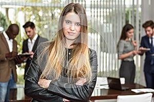 Businesswoman leader looking at camera in working environment.