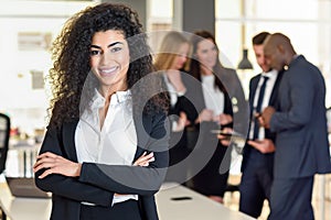 Businesswoman leader in modern office with businesspeople working at background