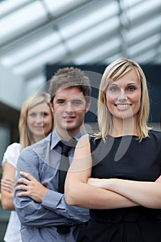 Businesswoman leading her team with folded arms