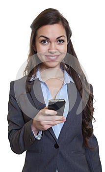 Businesswoman with long brown hair writing message with phone