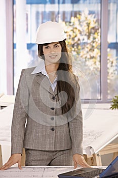 Businesswoman with long dark hair in hardhat