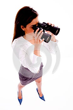 Businesswoman looking through binocular