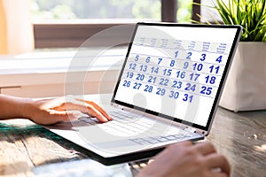 Businesswoman Looking At Calendar On Laptop