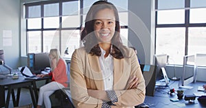 Businesswoman looking at camera in modern office