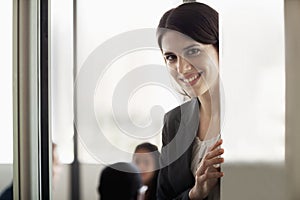 Businesswoman looking at the camera and smiling during a business meeting