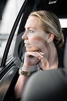 Businesswoman looking through car`s window