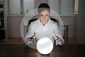 Businesswoman Looking In A Crystal Ball