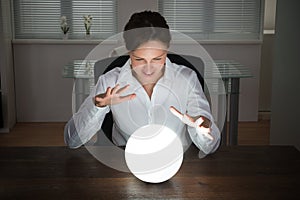 Businesswoman Looking In A Crystal Ball