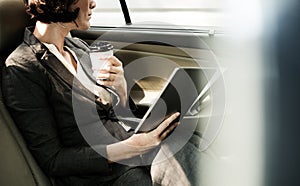 Businesswoman looking out through a car window