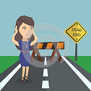 Businesswoman looking at road sign dead end.