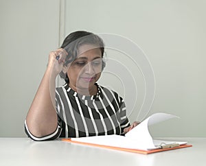 Businesswoman looking at some documents on a file