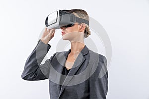Businesswoman looking at visual reality world by using VR glass. Contraption.