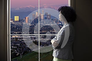 Businesswoman in Los Angeles Looking at Office Window