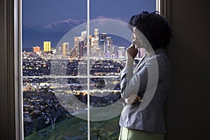 Businesswoman in Los Angeles Looking at Office Window